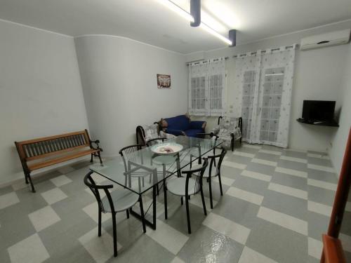 a living room with a table and chairs and a couch at Villetta Roby in Marina di Modica