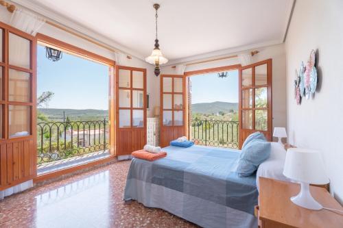 a bedroom with a bed and a balcony at El Cachorro in Altura