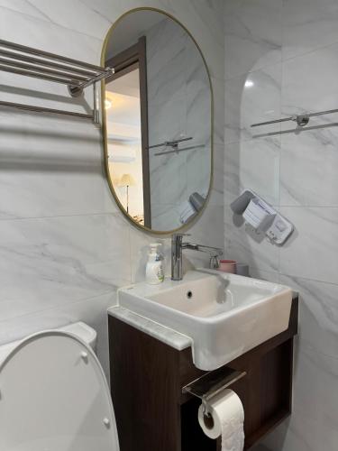 a white bathroom with a sink and a mirror at The One Condo - Family Suite 2BDR Pool View in Chiang Mai