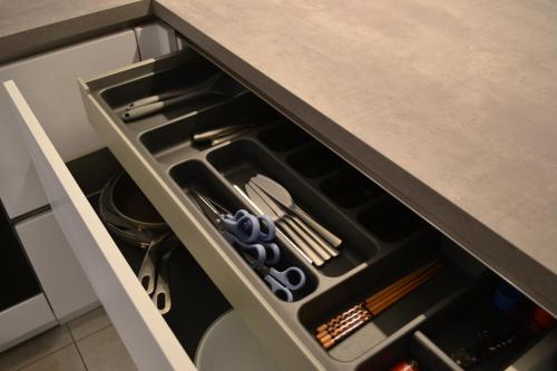 a drawer in a kitchen with utensils in it at Modernes 2-Zimmer Apartment mit Balkon in Münster