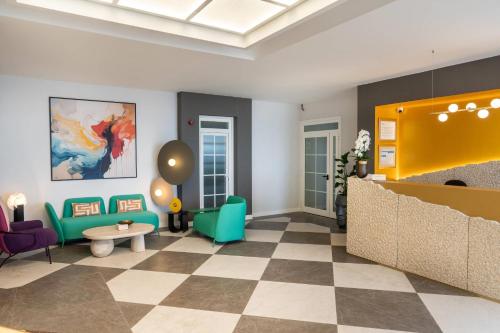 a lobby with colorful furniture and a checkered floor at Hotel Faranda Rias Altas, Ascend Hotel Collection in Oleiros