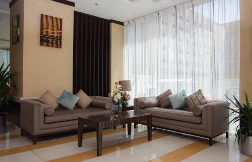 a living room with two couches and a coffee table at Dalin Hotel in Riyadh