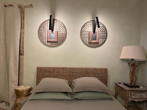 a bedroom with three mirrors on the wall and a bed at La Noccemada, maison d'hôtes in Saint-Julien