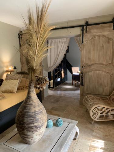 a large vase sitting on a table in a bedroom at La Noccemada, maison d'hôtes in Saint-Julien