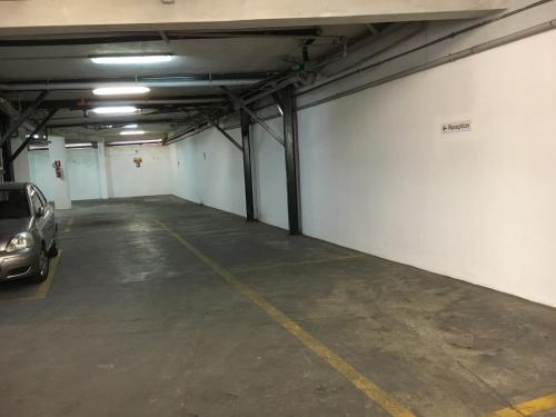 a parking garage with a car parked in it at Albergo Athenaeum in Palermo