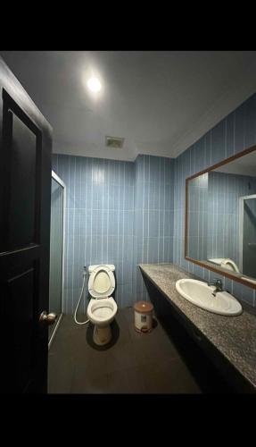 a bathroom with a toilet and a sink and a mirror at RatanakCity hotel in Banlung