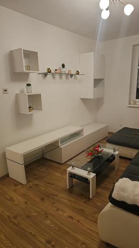 a white living room with a bench in a room at Ferienwohnung Christian in Stinatz