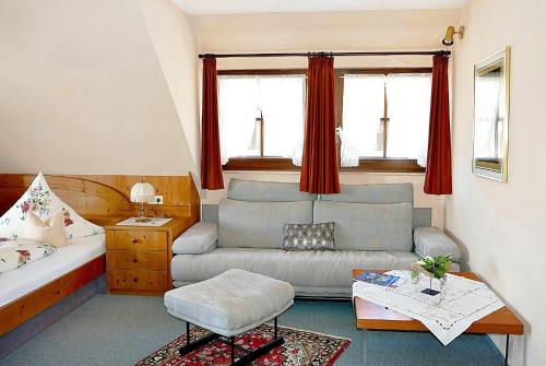 a living room with a couch and a table at Landhaus Seiler in Kniebis