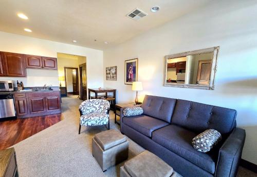 a living room with a couch and a kitchen at Whitefish Downtown Suites in Outback Mobile Home Settlement
