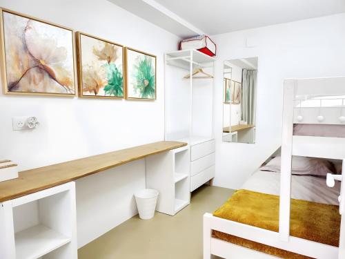 a bedroom with white walls and a bunk bed at Villa Alekatele in La Tranche-sur-Mer