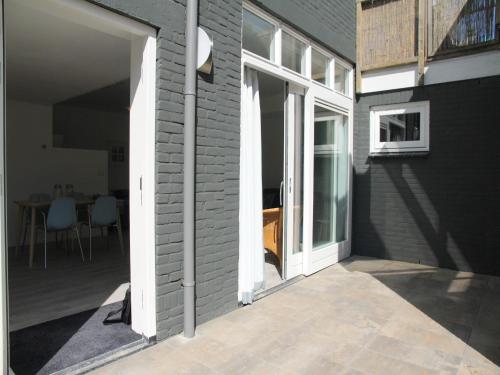 an open door of a house with a patio at Stunning apartment in Schoorl, North Hollandâ you can bike to the beach in Schoorl