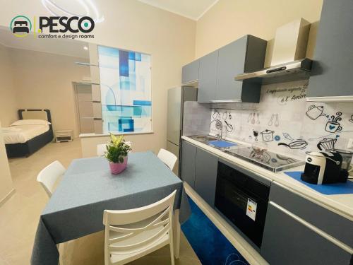 a kitchen with a table with chairs and a counter top at Pesco Rooms Marineo in Marineo