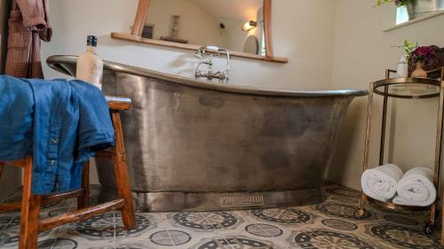 Una gran bañera de metal en un baño con espejo. en Host & Stay - Tin Bath, en Aller