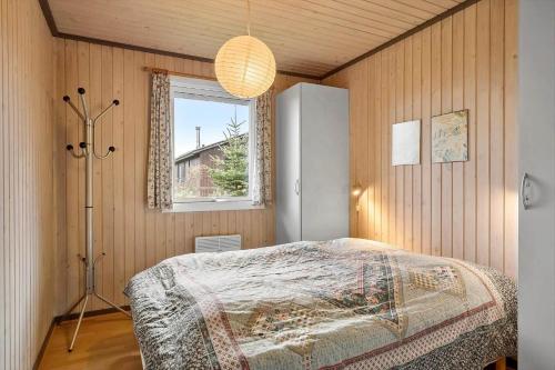 a bedroom with a bed in a room with a window at LL258-Humble-Paradisvejen-11 in Østerskov