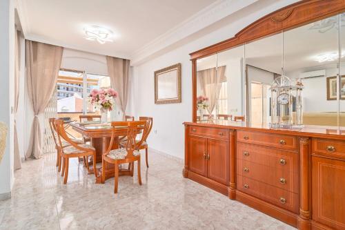 a dining room with a table and a large mirror at Casa Ramos Con Jacuzzi in Nerja