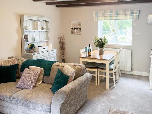 a living room with a couch and a table at The Old Barn-E1425 in Winthorpe