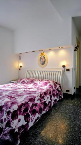 a bedroom with a bed with a purple blanket at B&B da Jordan in Gorgonzola