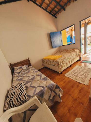 a bedroom with two beds in a room at Chalé tangará praia do sono in Ponta Negra