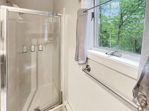 a bathroom with a shower and a window at Sugar Hollow in Mendon