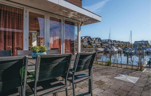 two chairs sitting on a porch overlooking a marina at Saskerlei in Uitgeest