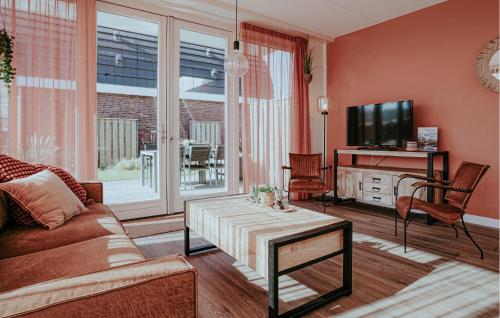 a living room with a couch and a tv at Saskerlei in Uitgeest