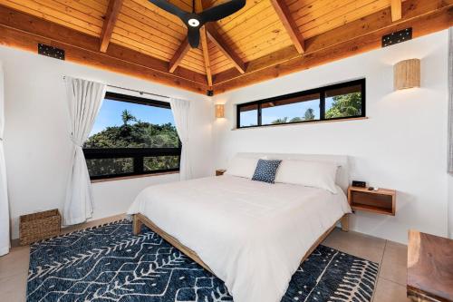 a bedroom with a bed and a ceiling fan at Manu O Ku in Kailua-Kona