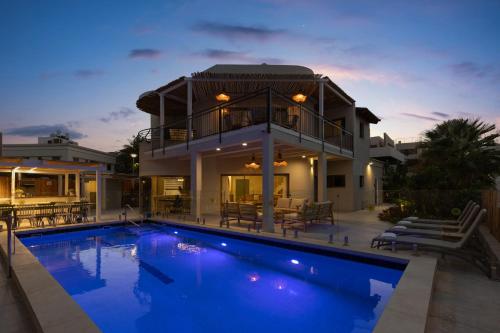 a house with a swimming pool in front of a house at Ella Sun - Coconut Villa in Eilat