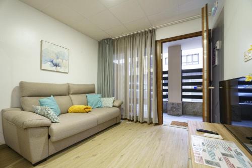 a living room with a couch and a table at Sophie Apartamentos - Burela in Burela de Cabo