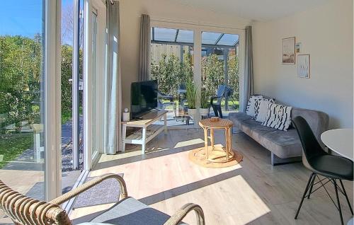 a living room with a couch and a tv at 2 Bedroom Stunning Home In Heinkenszand in Heinkensand