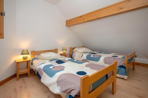 Postel nebo postele na pokoji v ubytování Chalet 228 - Village nordique