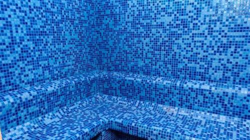 塞拉莱Bristol Hotel Long Stayer的浴室设有蓝色瓷砖浴缸。