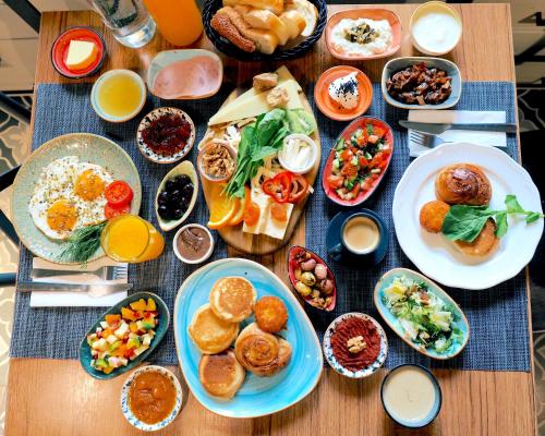 a table with plates of food on a table at Hotel Poem in Istanbul