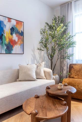 a living room with a couch and a table at The Khorfakkan Suite by Riviera in Khor Fakkan