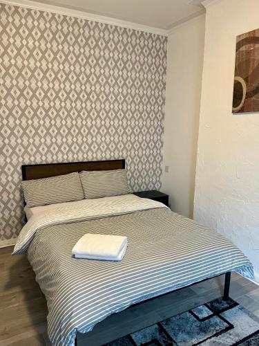 a bedroom with a bed with a towel on it at Southend escape in Southend-on-Sea