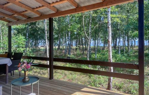 a porch with a table and a vase of flowers at 2 Bedroom Gorgeous Home In Højslev in Højslev