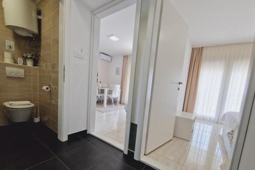 a bathroom with a shower and a toilet and a table at Seaview Studio Apartmani Sleeps 2 - WiFi & Tv in Crikvenica
