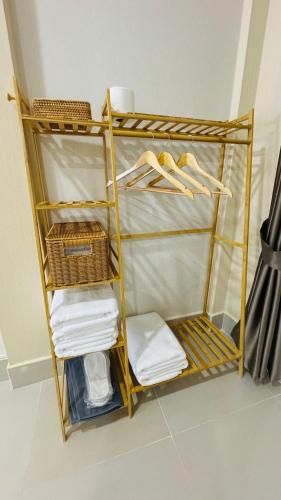 a room with a shelf with towels and baskets at Chun Pa House in Sathani Khlong Rian