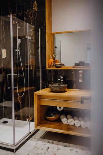 a bathroom with a shower and a glass shower stall at Sky Suites & Sky Bar in Weimar