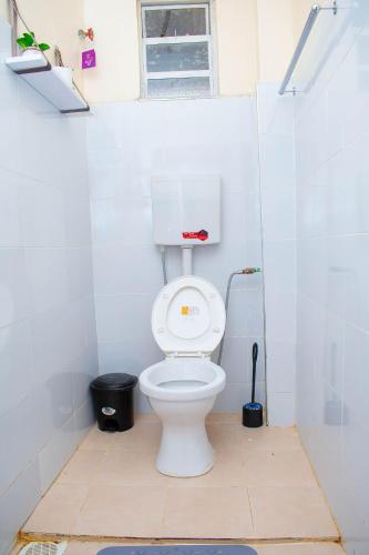 a bathroom with a white toilet in a stall at SJ Homes in Eldoret