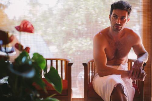 a man sitting in a chair in front of a window at Villa Abbondanzi Resort in Faenza