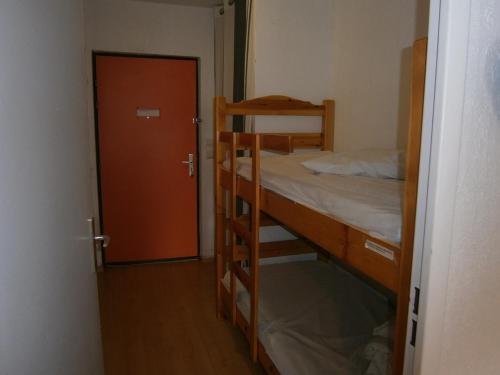 a room with two bunk beds and a door at Studio Les Fontettes 2 in Le Dévoluy