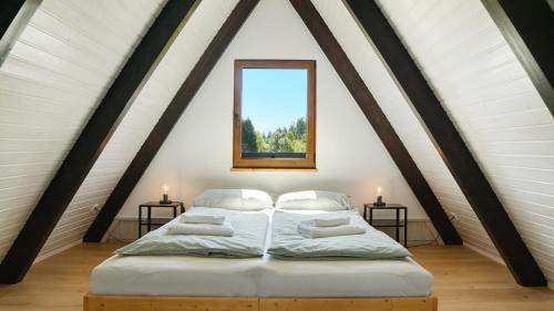 a bedroom with two beds in a attic at Ferienhaus Auszeit mit Terrasse in Tennenbronn