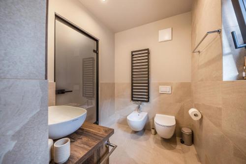 a bathroom with a white sink and a toilet at Apartment 16 cityview in Cornedo all'Isarco