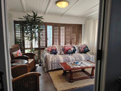 a living room with a couch and a table at Twelveon1st in Cape Town