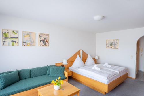 a living room with a couch and a bed at Fewo Schneckenhalde App 18 in Bad Säckingen