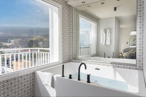 a bathroom with a sink and a large window at TUI BLUE Atlantic Hills in Puerto de la Cruz