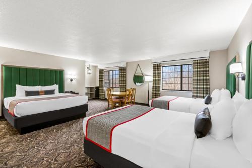 een hotelkamer met twee bedden en een tafel bij Lumber Jack Lodge, an Ascend Collection Hotel in West Branch