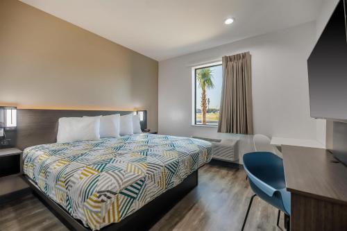 a hotel room with a bed and a window at Studio 6 Giddings in Giddings