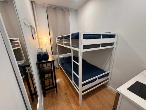 a bedroom with two bunk beds in a room at Room with Kitchen in Chelsea - Shared Bathroom - 3rd Floor Walk-UP in New York