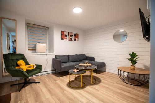 a living room with a couch and a table at Les Voûtes Royal Urbain, Parking, Pet friendly in Quebec City